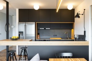 black wooden furniture and an industrial lamp above a coffee mac